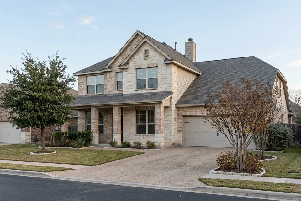 Illustration of a two-story stone and brick suburban house