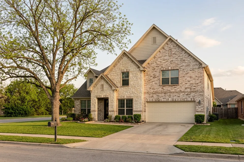 Illustration of a two-story stone and brick suburban house