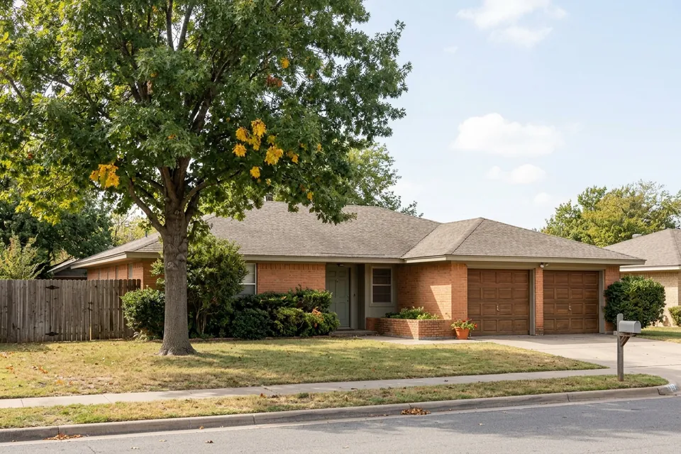 Illustration of a 1970s brick ranch house with a two-car garage