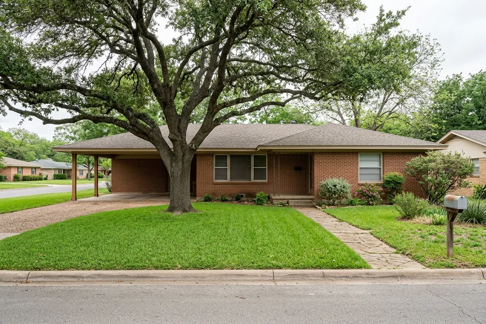 Illustration of a 1960s brick ranch house with a carport