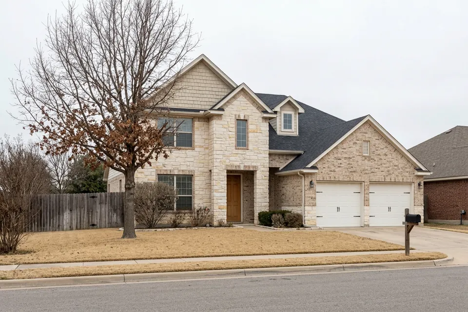 Illustration of a two-story stone and brick suburban house