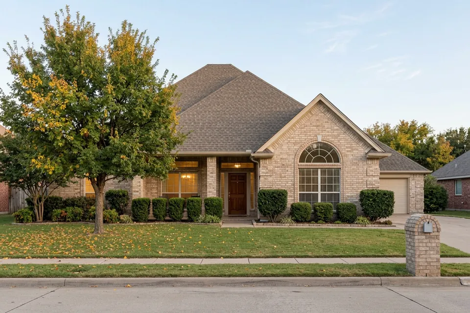 Illustration of a 1990s tan brick house with a tall roof