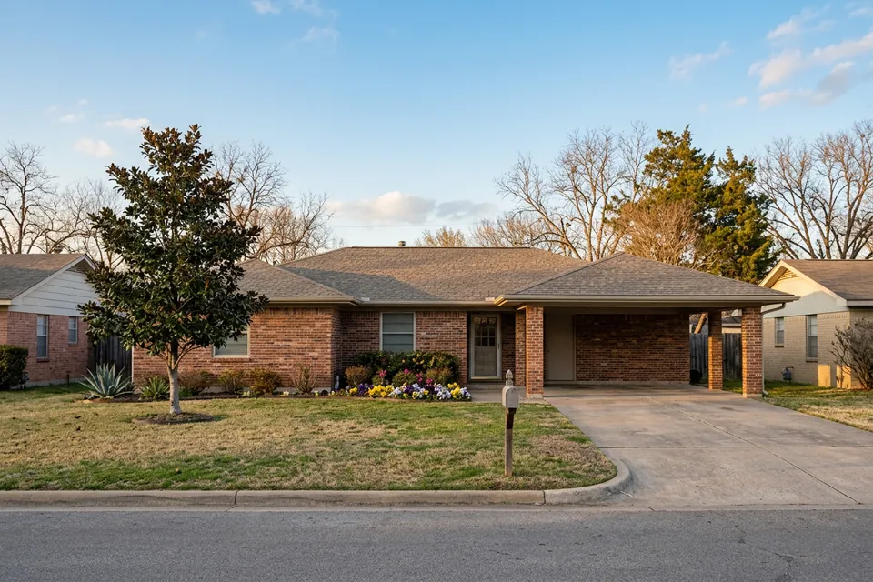 Illustration of a 1960s brick ranch house with a carport