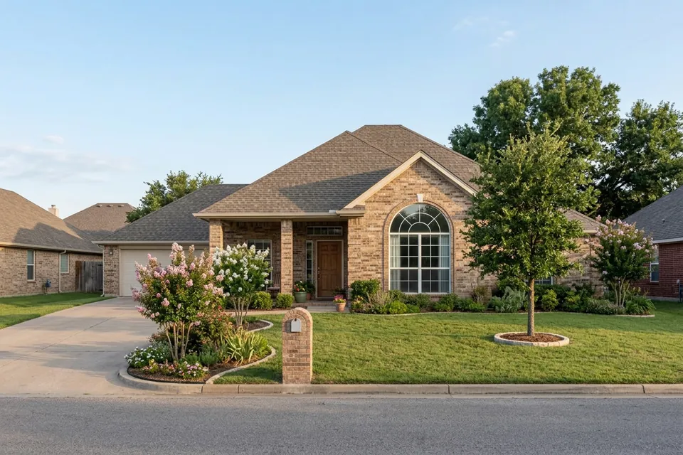 Illustration of a 1990s tan brick house with a tall roof