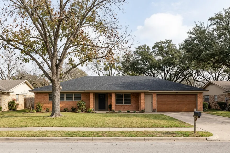 Illustration of a 1970s brick ranch house with a two-car garage
