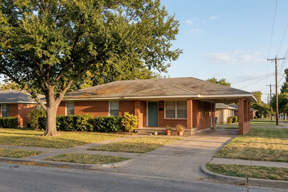 Illustration of a 1960s red brick ranch house with a carport