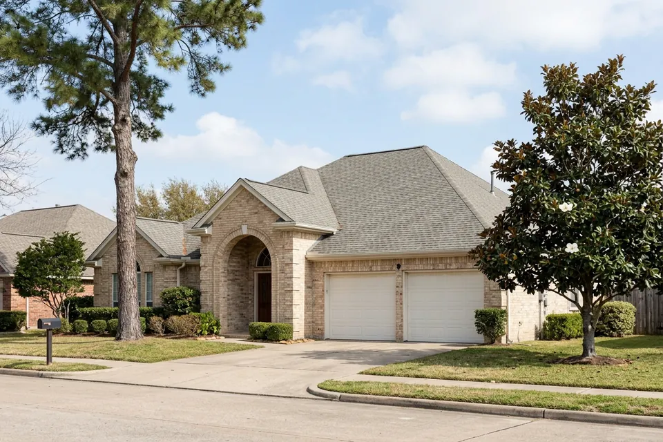 Illustration of a 1980s tan brick house with an arched entry